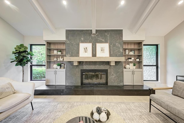 10507 Spicewood Pkwy, Austin, TX 78750 - living area featuring wood finished floors, beamed ceiling, and a tile fireplace