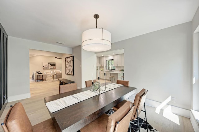 10507 Spicewood Pkwy, Austin, TX 78750 - dining room featuring light wood-style flooring and baseboards