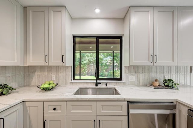 10507 Spicewood Pkwy, Austin, TX 78750 - kitchen with dishwasher, tasteful backsplash, white cabinetry, and light stone countertops