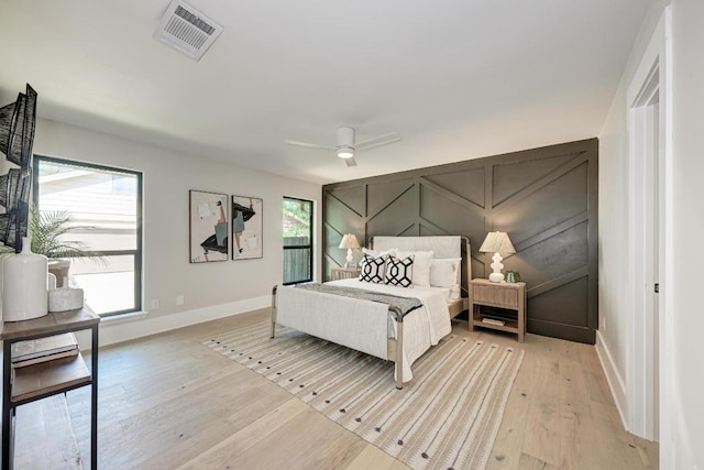 10507 Spicewood Pkwy, Austin, TX 78750 - bedroom featuring a decorative wall, light wood-style flooring, and a ceiling fan