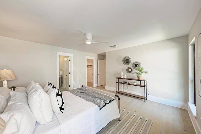 10507 Spicewood Pkwy, Austin, TX 78750 - bedroom with light wood-type flooring, ceiling fan, and ensuite bath