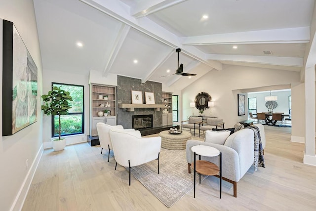 10507 Spicewood Pkwy, Austin, TX 78750 - living room featuring light wood-style flooring, a tiled fireplace, healthy amount of natural light, ceiling fan, and recessed lighting