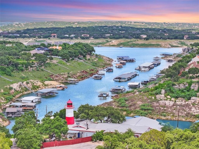 405 Alva Dr, Spicewood, TX 78669 - aerial view at dusk of a water view and view of wooded area