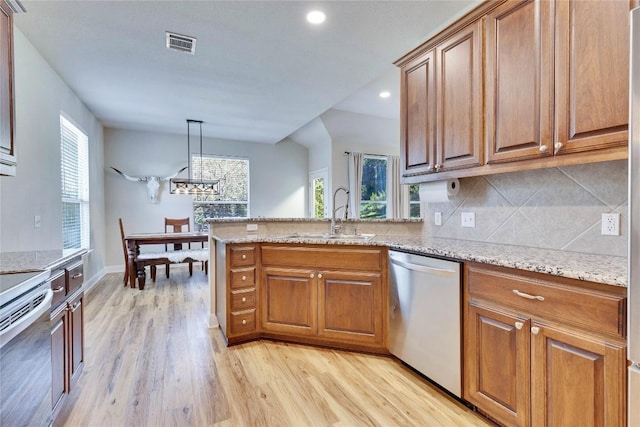 405 Alva Dr, Spicewood, TX 78669 - kitchen with dishwasher, brown cabinetry, light wood-style flooring, and recessed lighting