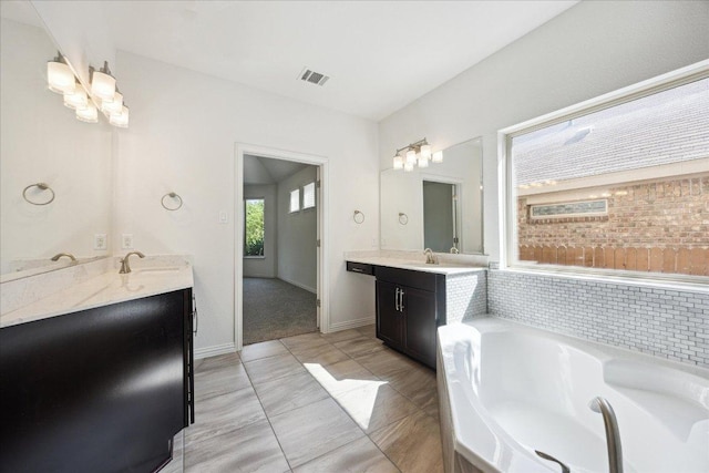 123 Pond View Pass, Buda, TX 78610 - bathroom with two vanities and a bath
