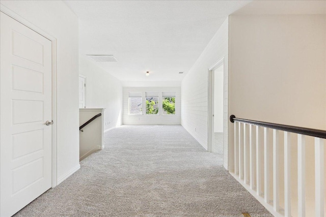 123 Pond View Pass, Buda, TX 78610 - corridor featuring carpet and an upstairs landing