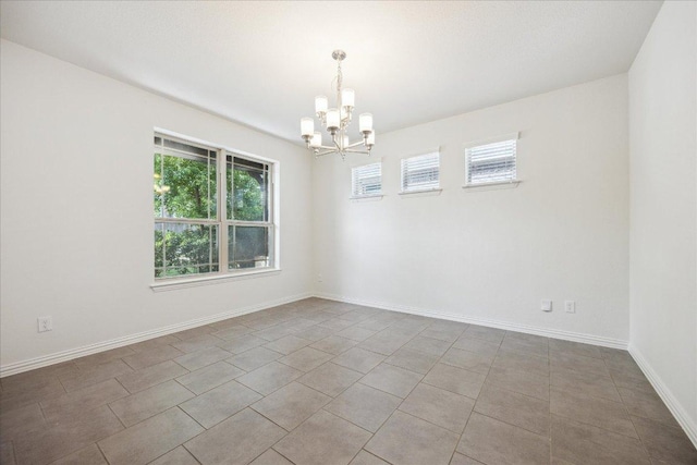 123 Pond View Pass, Buda, TX 78610 - tiled empty room with a chandelier and baseboards