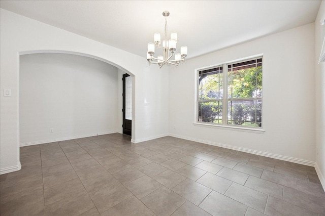 123 Pond View Pass, Buda, TX 78610 - tiled spare room featuring arched walkways and a chandelier