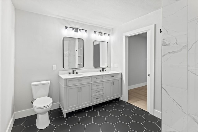 3907 Carmel Dr, Austin, TX 78721 - bathroom with double vanity and toilet