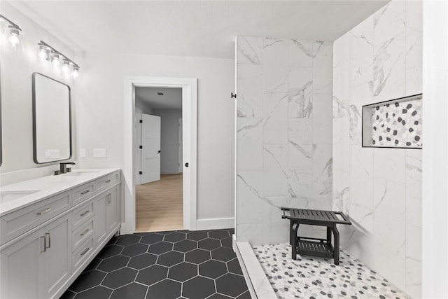 3907 Carmel Dr, Austin, TX 78721 - full bath with double vanity, a marble finish shower, and tile patterned floors