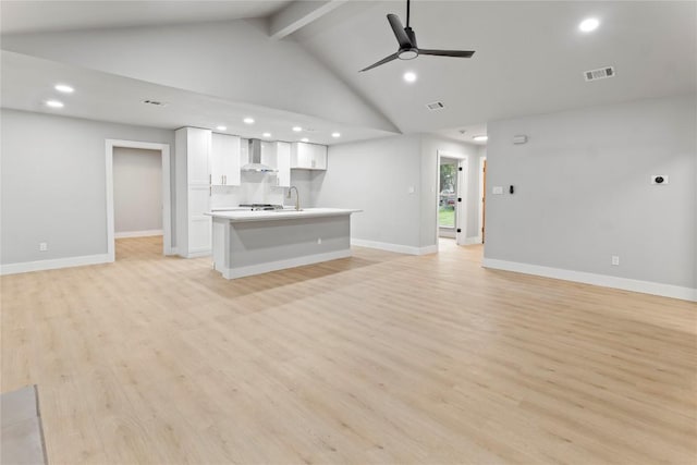 3907 Carmel Dr, Austin, TX 78721 - unfurnished living room featuring beamed ceiling, ceiling fan, recessed lighting, light wood finished floors, and high vaulted ceiling