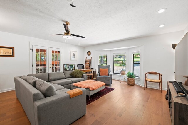 703 Stagecoach Trl, San Marcos, TX 78666 - living room featuring recessed lighting, light wood-style flooring, a textured ceiling, and a ceiling fan