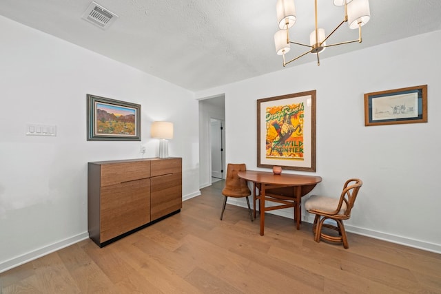 703 Stagecoach Trl, San Marcos, TX 78666 - dining room featuring light wood-type flooring and a chandelier
