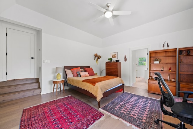 703 Stagecoach Trl, San Marcos, TX 78666 - bedroom with wood finished floors, lofted ceiling, a desk, ceiling fan, and ensuite bathroom