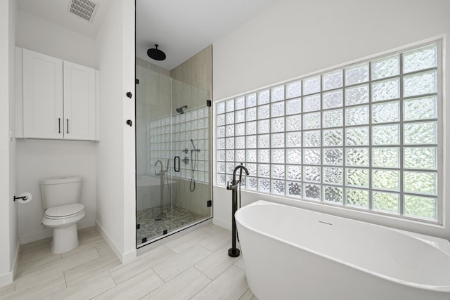703 Stagecoach Trl, San Marcos, TX 78666 - full bathroom with a shower stall, a freestanding bath, and healthy amount of natural light