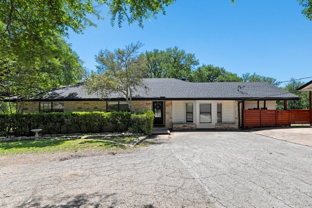 703 Stagecoach Trl, San Marcos, TX 78666 - view of front of home with stone siding, asphalt driveway, and roof with shingles