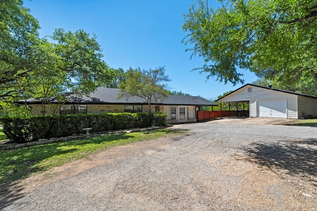 703 Stagecoach Trl, San Marcos, TX 78666 - single story home with dirt driveway, a detached garage, and an outbuilding