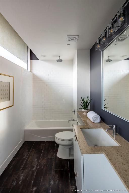 601 Brushy St Unit 106, Austin, TX 78702 - bathroom with vanity, a combined bath / shower with rainfall shower, and wood finished floors