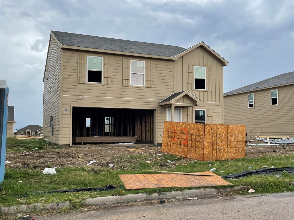 202 Fred Patrick Dr, Killeen, TX 76542 - view of front of home with board and batten siding, an attached garage, and a shingled roof