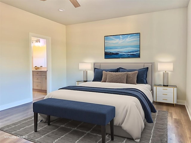 142 E Pauwela Ln, Bastrop, TX 78602 - bedroom featuring wood finished floors, ensuite bath, recessed lighting, and ceiling fan