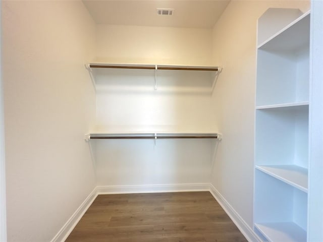 142 E Pauwela Ln, Bastrop, TX 78602 - walk in closet featuring dark wood-style flooring