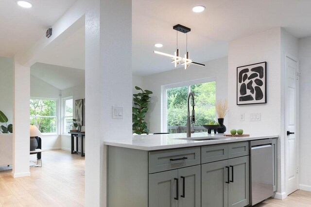 1402 Monica St, Austin, TX 78758 - kitchen with light wood-style floors, gray cabinetry, light countertops, recessed lighting, and healthy amount of natural light