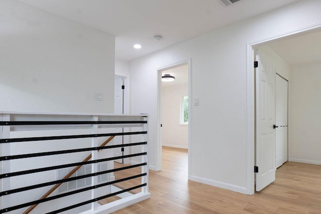 1402 Monica St, Austin, TX 78758 - hallway with light wood-type flooring, an upstairs landing, and recessed lighting