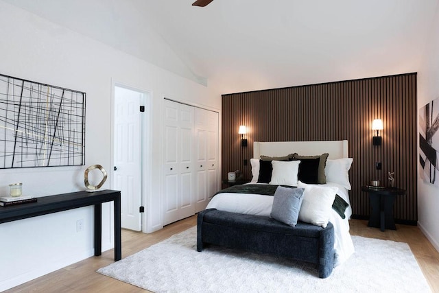 1402 Monica St, Austin, TX 78758 - bedroom featuring wood finished floors, two closets, and high vaulted ceiling