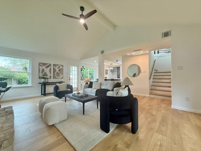 1402 Monica St, Austin, TX 78758 - living area featuring beamed ceiling, ceiling fan, light wood-type flooring, stairway, and high vaulted ceiling