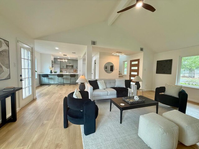 1402 Monica St, Austin, TX 78758 - living area featuring light wood-style flooring, beamed ceiling, ceiling fan, healthy amount of natural light, and high vaulted ceiling