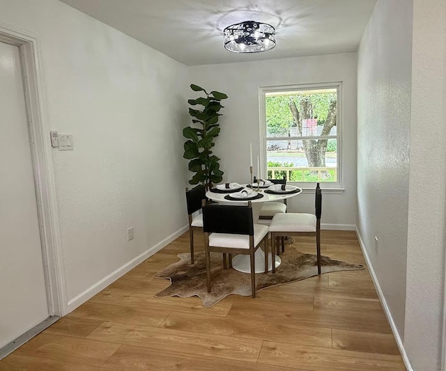 1402 Monica St, Austin, TX 78758 - dining area with light wood finished floors and baseboards