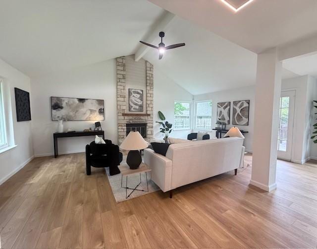 1402 Monica St, Austin, TX 78758 - living area featuring a ceiling fan, light wood finished floors, plenty of natural light, and a fireplace