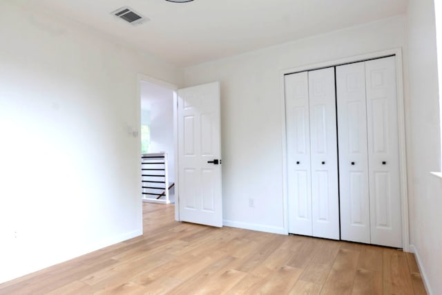 1402 Monica St, Austin, TX 78758 - unfurnished bedroom featuring light wood finished floors and a closet
