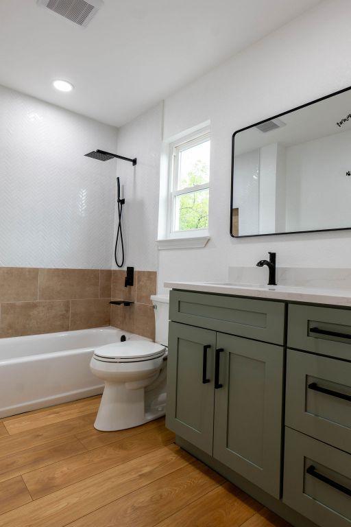 1402 Monica St, Austin, TX 78758 - bathroom with vanity and shower / tub combination