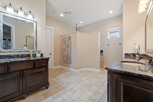 309 Grand Oaks Ln, Georgetown, TX 78628 - bathroom with walk in shower, two vanities, and recessed lighting