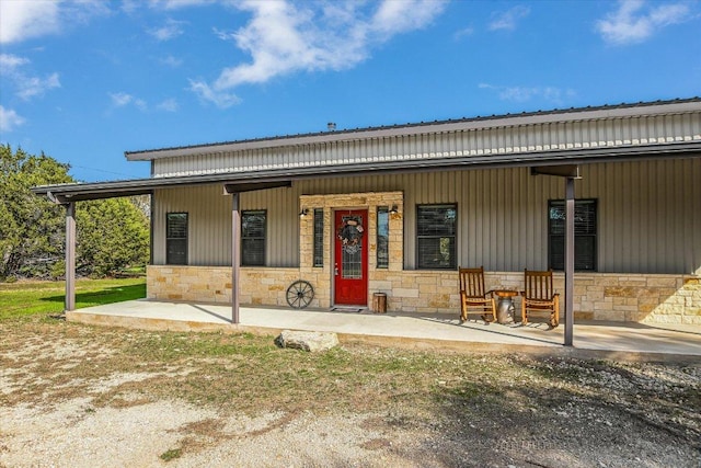 542 Stars And Stripes, Fischer, TX 78623 - view of front of property with covered porch, stone siding, and a metal roof