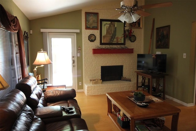 201 E Noton St Unit 105, Pflugerville, TX 78660 - living area with ceiling fan, wood finished floors, lofted ceiling, and a brick fireplace