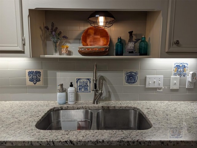 201 E Noton St Unit 105, Pflugerville, TX 78660 - kitchen view of backsplash and light stone countertops