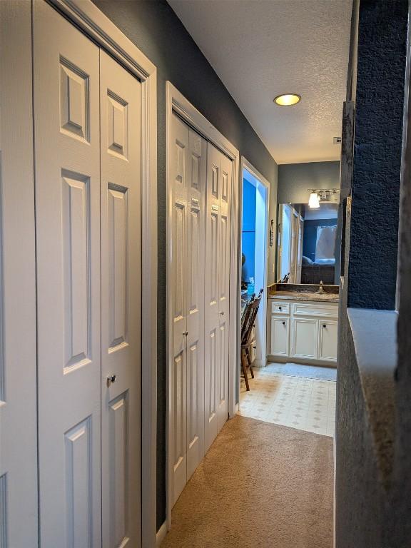 201 E Noton St Unit 105, Pflugerville, TX 78660 - hall with a textured ceiling, light colored carpet, and recessed lighting