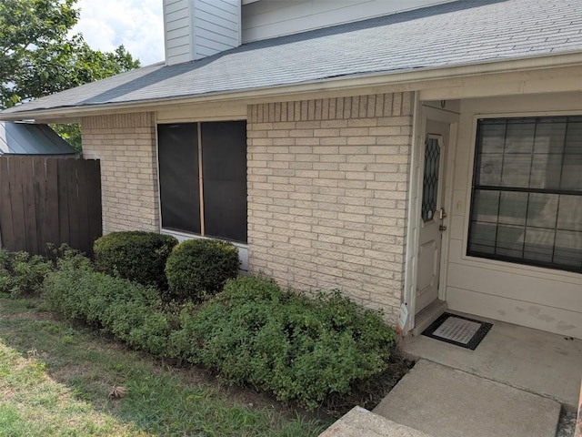201 E Noton St Unit 105, Pflugerville, TX 78660 - entrance to property featuring brick siding, roof with shingles, and a chimney