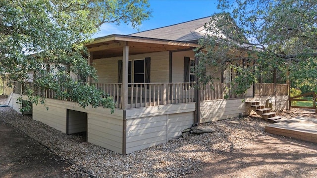 111 Lazy Trail Ct, Liberty Hill, TX 78642 - view of property exterior with a porch, roof with shingles, and stairs
