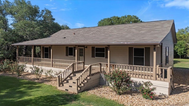 111 Lazy Trail Ct, Liberty Hill, TX 78642 - view of front of home featuring roof with shingles, a porch, and a front lawn