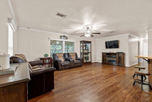 111 Lazy Trail Ct, Liberty Hill, TX 78642 - living area with a ceiling fan, a fireplace, dark wood finished floors, and crown molding