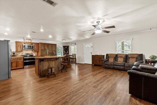 111 Lazy Trail Ct, Liberty Hill, TX 78642 - living area featuring ornamental molding, ceiling fan, wood finished floors, and recessed lighting