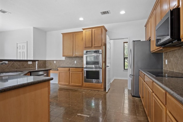 605 Whistlers Walk Trl, Cedar Park, TX 78613 - kitchen featuring stainless steel appliances, recessed lighting, backsplash, dark stone countertops, and dark tile patterned flooring