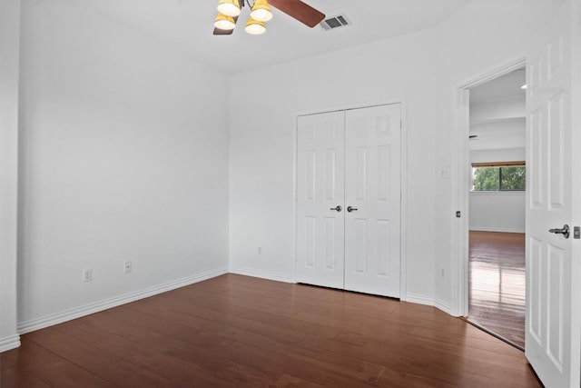 605 Whistlers Walk Trl, Cedar Park, TX 78613 - unfurnished bedroom featuring dark wood-style flooring, a ceiling fan, and a closet