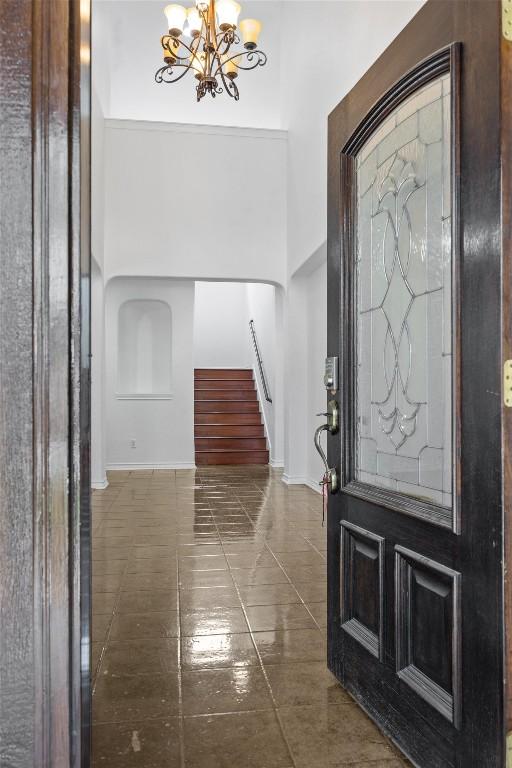 605 Whistlers Walk Trl, Cedar Park, TX 78613 - foyer with a chandelier, stairway, tile patterned floors, and a towering ceiling