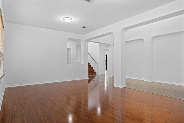 605 Whistlers Walk Trl, Cedar Park, TX 78613 - empty room featuring wood finished floors, stairs, and arched walkways