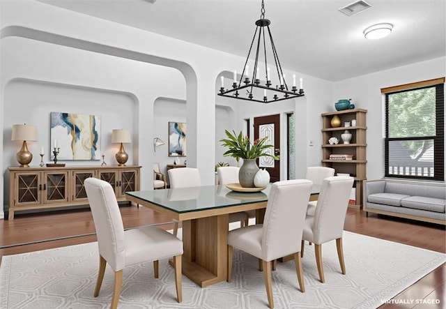 605 Whistlers Walk Trl, Cedar Park, TX 78613 - dining room with wood finished floors, a chandelier, and arched walkways