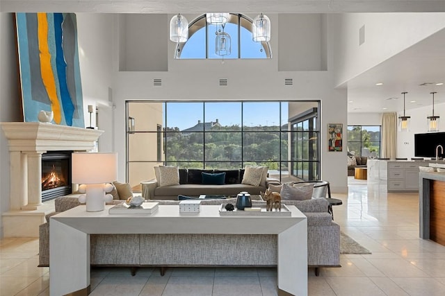 1508 Mesa Ridge Ln, Austin, TX 78735 - living area with a lit fireplace, light tile patterned floors, and a high ceiling